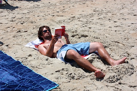 Isaac reading on the beach.JPG