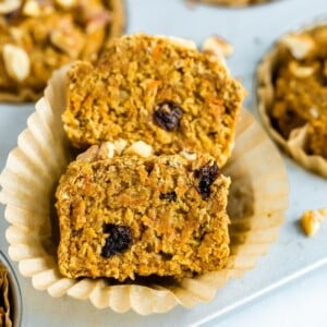 Oat bran muffin made with shredded carrots and raisins sliced in half.