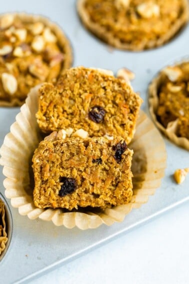 Oat bran muffin made with shredded carrots and raisins sliced in half.