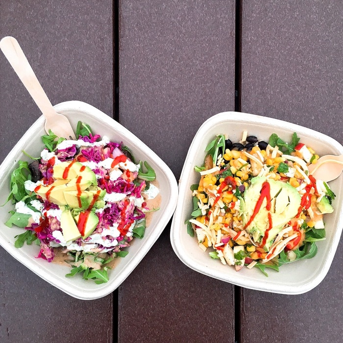 Overhead photo of two bowls with salads inside.