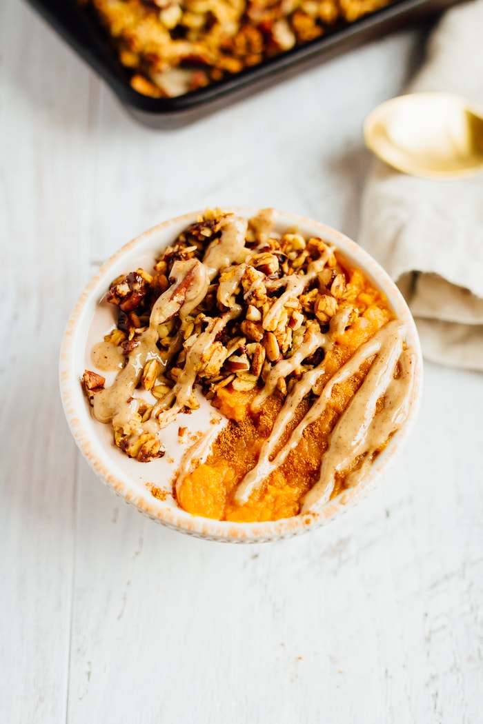 Chocolate Pecan Pumpkin Granola Bowl of yogurt, granola and pumpkin topped with a drizzle of nut butter.