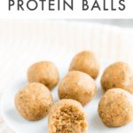 Seven coconut protein balls on a white plate with a bite out of one. Text on top reads "Coconut Protein Balls"