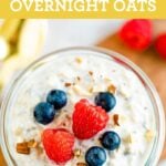 Jar of overnight oats topped with almonds and berries.