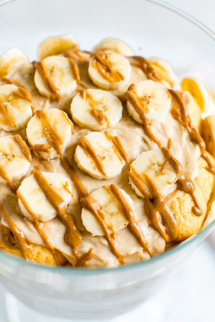 Peanut butter banana pudding topped with slices of bananas and a drizzle of peanut butter.