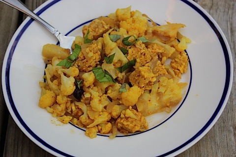 A plate of curried cauliflower and tempeh.