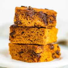 Stack of three pumpkin bars with chocolate chips.