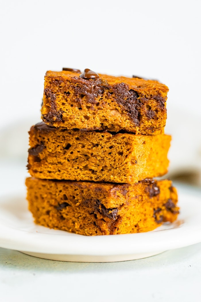 Stack of three pumpkin bars with chocolate chips.