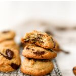 Stack of three almond flour chocolate chip cookies. Top cookie had a bite taken out of it.