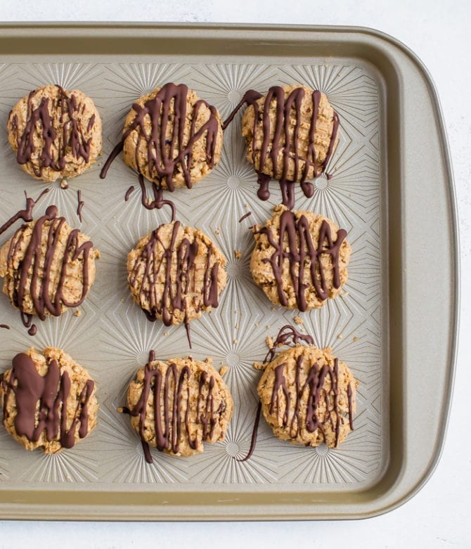 5-ingredient peanut butter granola cookies drizzled with chocolate.