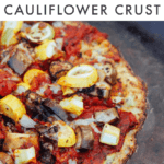 Cauliflower curst pizza on a baking sheet and topped with chopped veggies and tomato sauce. Text above reads "Healthy Pizza with a Cauliflower Crust"