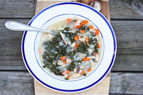 Overhead shot of Clean Food Autumn Harvest Soup in a bowl with blue trim.