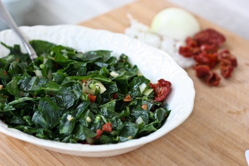 A serving bowl of Raw Collard Greens with Apple Cider Vinegar.