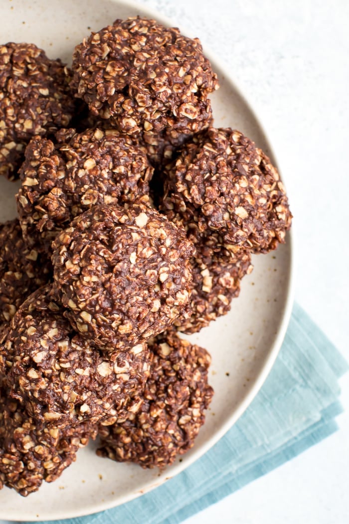 Plate full of peanut butter chocolate healthy no bake cookies with a folded napkin below the plate.