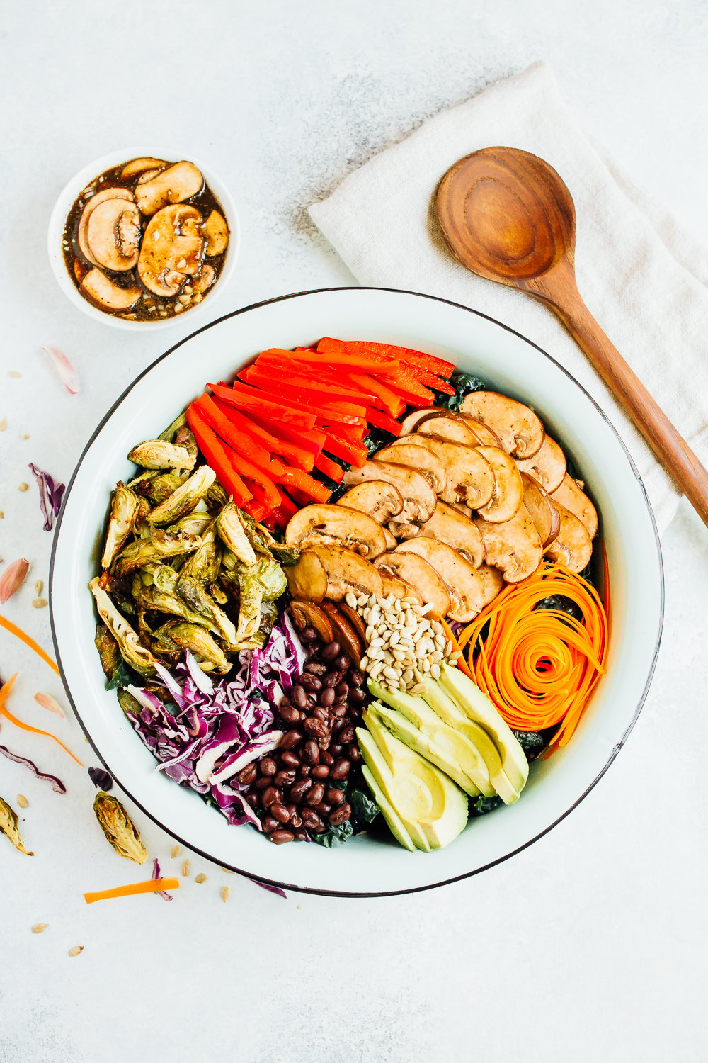 Overhead shot of a large bowl with ingredients sliced and spread about the bowl. 