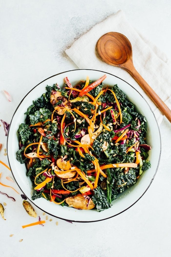 Overhead shot of large white salad bowl with mixed detox salad. 