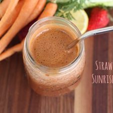 Sunrise smoothie in a mason jar with a silver metal straw.