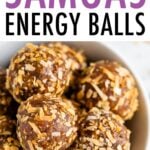 Bowl full of samoa energy balls rolled in toasted coconut.