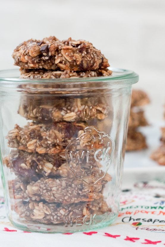 Glass jar with a stack of oatmeal chia cookies stored inside.
