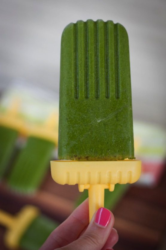 Hand holding a Green Smoothie Protein Popsicle.