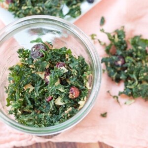 Overhead shot of kale granola in a glass jar.