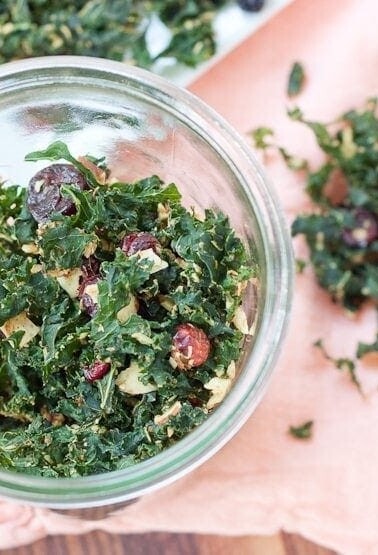 Overhead shot of kale granola in a glass jar.