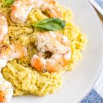 Pesto spaghetti squash topped with shrimp and basil.