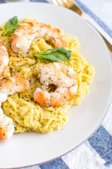 Pesto spaghetti squash topped with shrimp and basil.