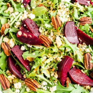 Arugula and beet salad topped with pecans and gorgonzola cheese.