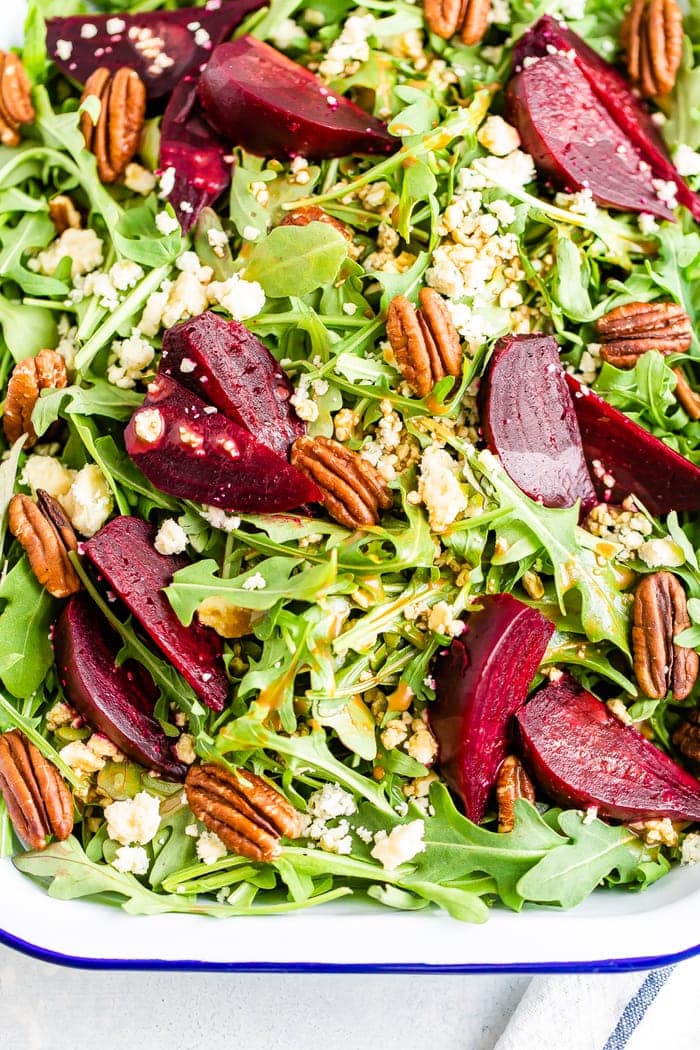 Arugula and beet salad topped with pecans and gorgonzola cheese.