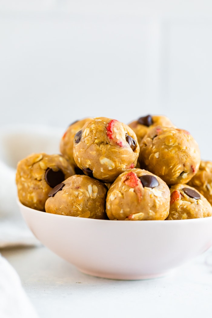 Bowl full of peanut butter and jelly protein bites with chocolate chips.