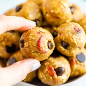 Hand holding a peanut butter and jelly protein ball.