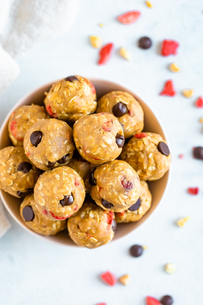 Bowl of peanut butter and jelly protein balls made with chocolate chips.