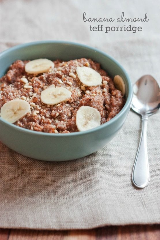 Banana Almond Teff Porridge in a light blue bowl with silver spoon.