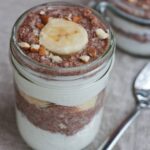 A jar of banana nut teff parfait with a silver spoon.