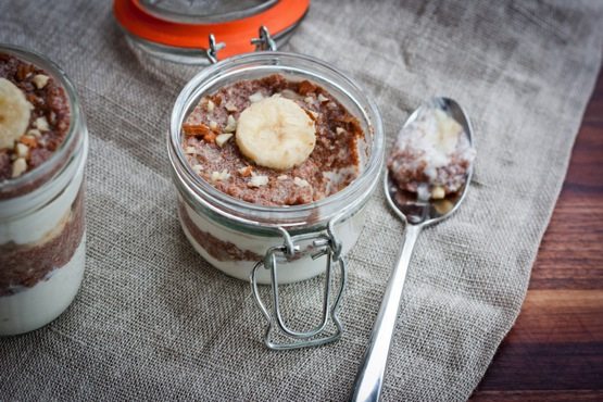 A small jar of banana nut teff parfait with a silver spoon.