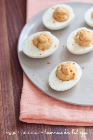 White plate with 3 hummus deviled eggs.