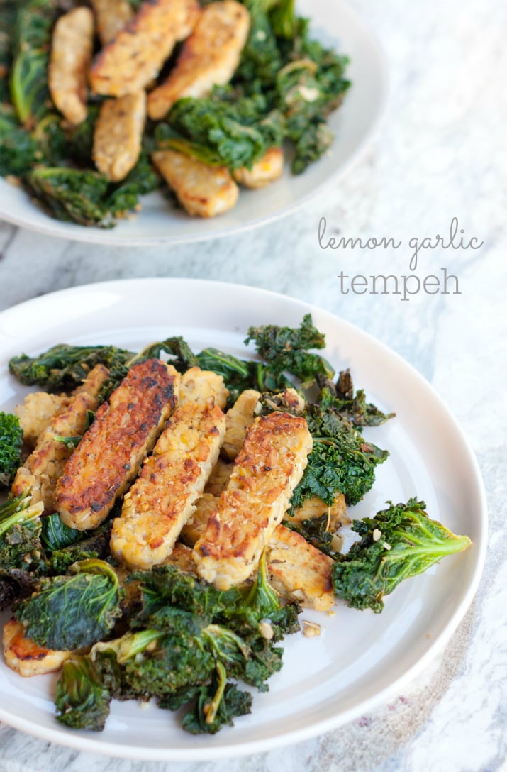 Lemon garlic tempeh slices over a bed of cooked kale. 