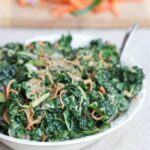 Spiralized Carrots and Cucumber Kale Salad with Peanut Sauce served in large white bowl on light grey table cloth.