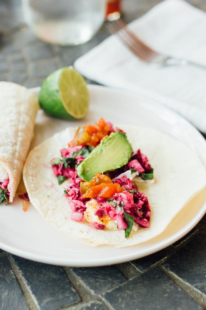 Get grilling with these clean eating fish tacos made with grilled white fish, honey dijon red cabbage slaw and grilled avocado. This healthy recipe is easy and perfect for warm summer nights when you don't even want to think about turning on the oven. 
