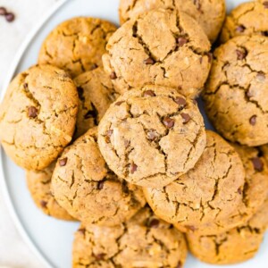 A plate full of chocolate chip tahini cookies.