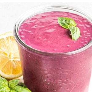Glass jar with blueberry basil smoothie.