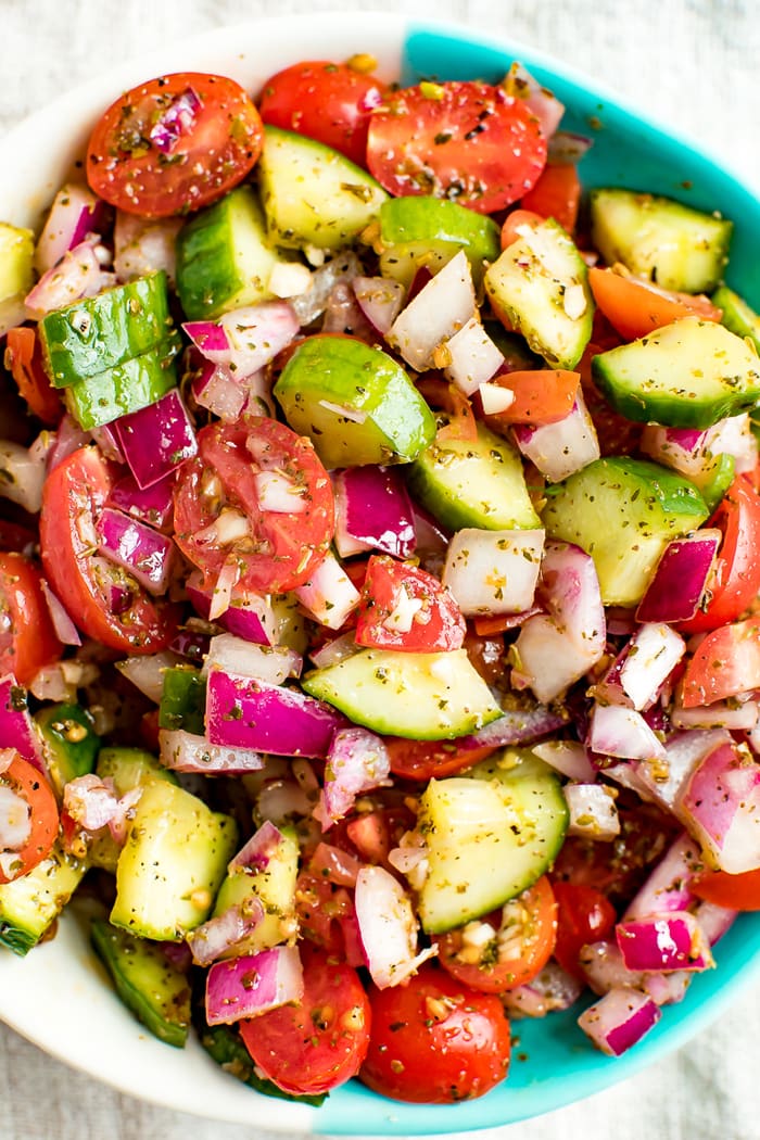 Overhead shot of cucumber tomato and red onion salad. 