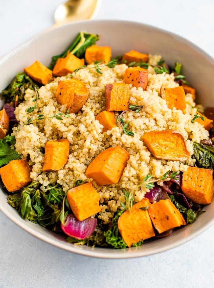 Bowl with a kale, quinoa and roasted sweet potato salad.