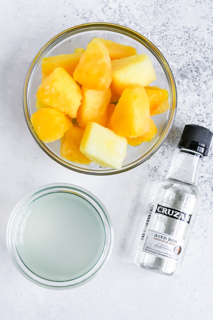 Ingredients for a skinny piña colada: frozen pineapple, coconut water and coconut rum.