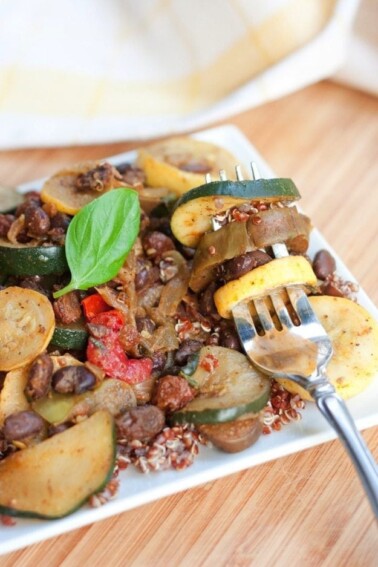 Curried Black Bean Ratatouille served on a white plate on wood cutting board.