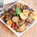 Curried Black Bean Ratatouille served on a white plate on wood cutting board.