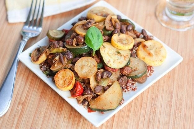 Curried Black Bean Ratatouille served on a white plate on wood cutting board.