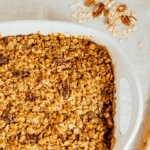 A baking dish of apple crisp with oatmeal pecan topping.