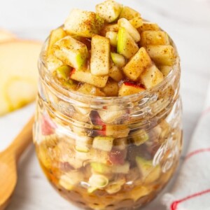 Raw apple pie filling a glass jar.