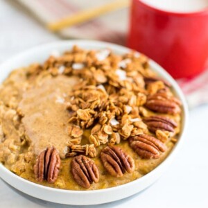 Protein egg white pumpkin oatmeal topped with peanut butter, granola, and pecans.